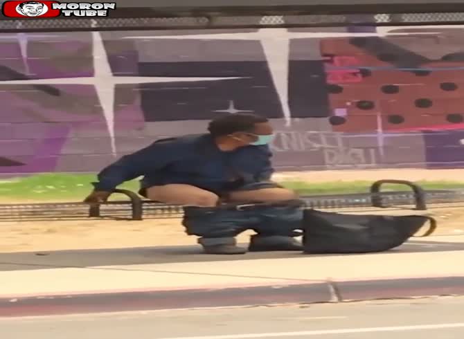 Video :A man uses a bus shelter to take care of his personal hygiene
